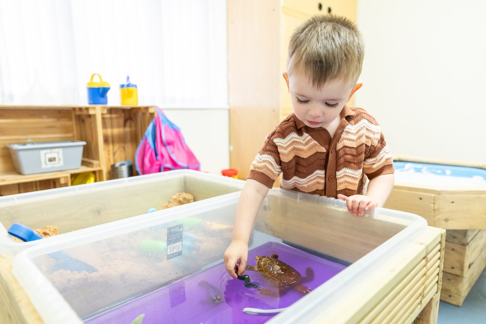 Playing at the sand and water tray